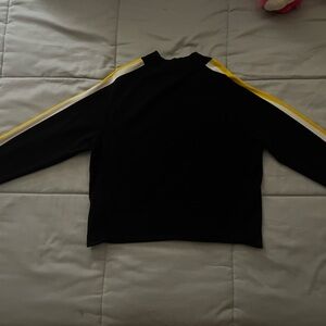 Fitted black shirt with yellow and white lines  turtle neck
